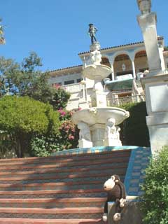 Fountain, stairs, sculpture, shrubbery.