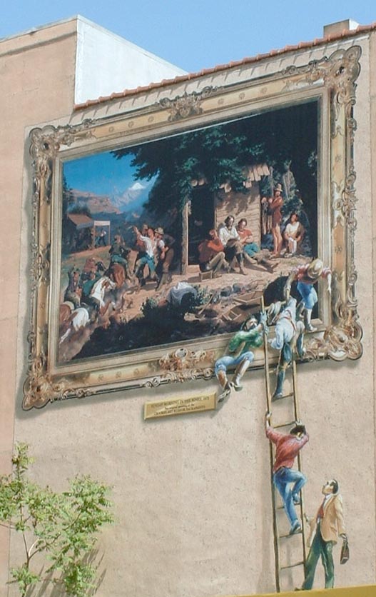 Painting of painting on side of building.
